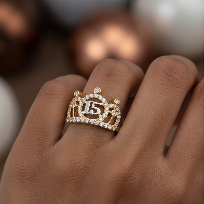 Gold ring with number 15 on a hand against a blurred background