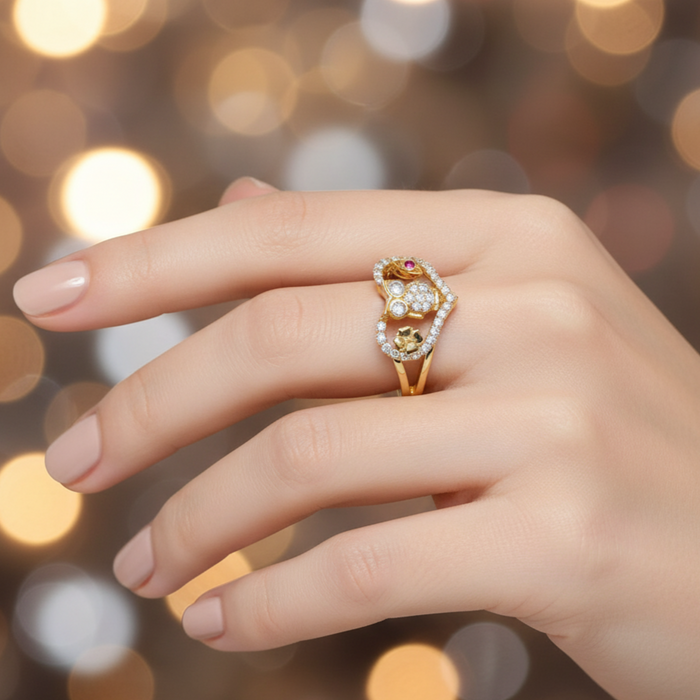Hand wearing a gold ring with gemstones against a blurred lights background