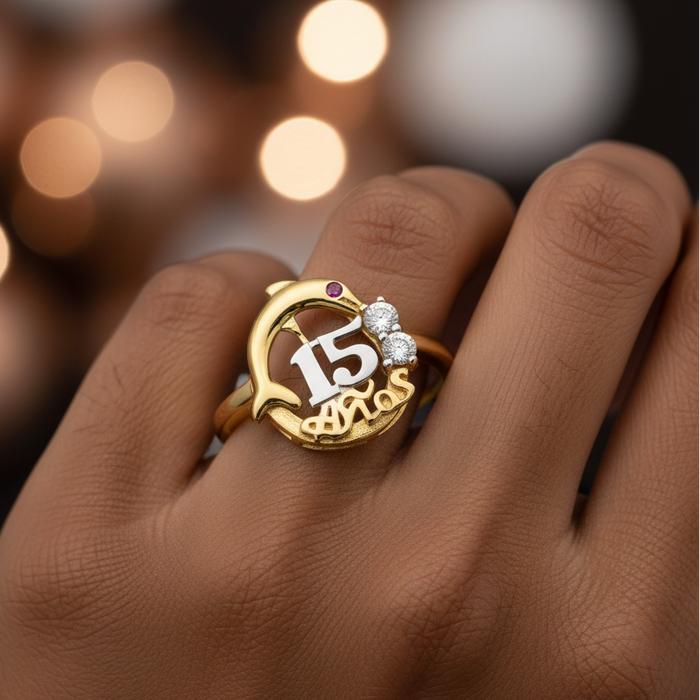 Gold ring with number 15 on a hand against a blurred lights background