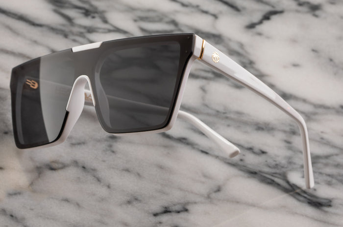 Side view of Heat Wave Visual Womens Clarity Sunglasses with white frame and black lens.
