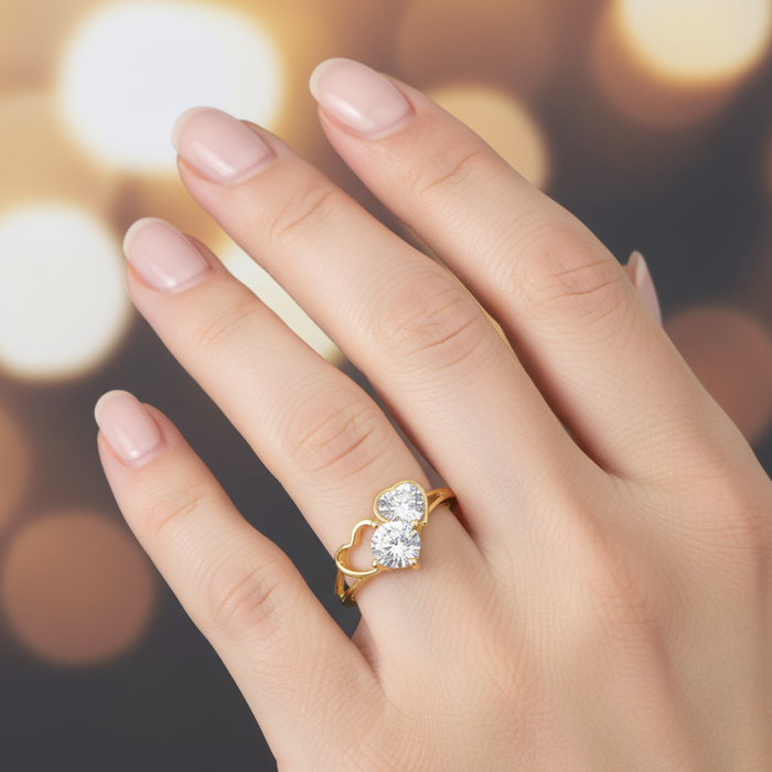 Hand wearing a gold ring with a large diamond on a blurred background