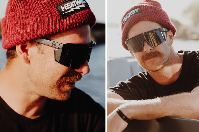 Mustached man wearing Heat Wave Visual Future Tech Sunglasses with black frame and black lens.