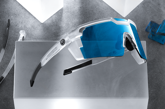 Indoor studio shot of the Future Tech Sunglasses: Vapor Frost Frame Coastal Lens Z87+ with clear side shields on a concrete block.