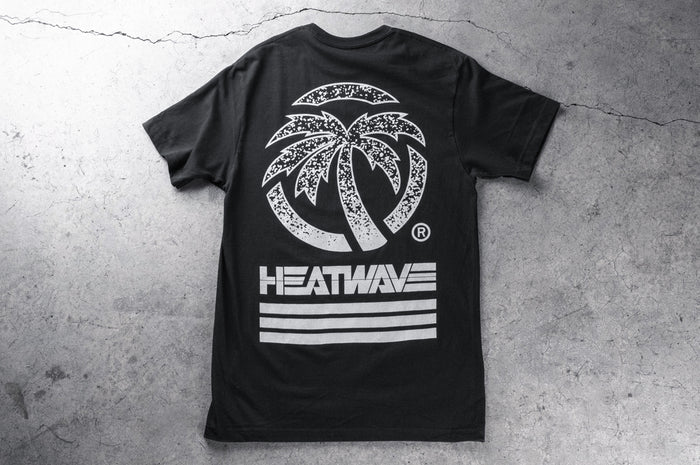 Backside shot of the Heat Wave Alloy T-Shirt on a concrete floor.
