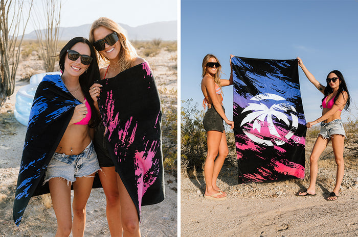 Two women wearing and holding the Heat Wave Baja Nights Towel outside