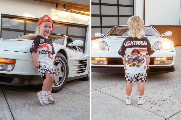Child wearing the Little Trouble x Heat Wave Kids Short Sleeve Jersey - White showing the front and backside