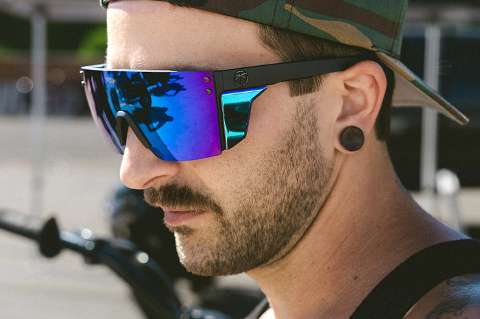 Biker rocking the  Heat Wave Visual Performance Lazer Face Sunglasses with black frame, piff green blue lens and matching colored side shields.