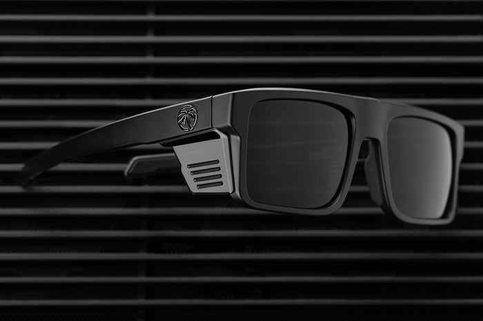 Lying on the ground is the Heat Wave Visual Performance Rayth Ultra Black Sunglasses.
