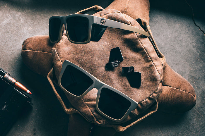 Two pairs of the Performance Vise Sunglasses: FDE Fader Z87+ on a brown bag with side shields