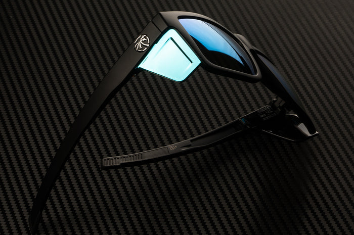 Side profile of the Heat Wave Visual Performance Vise Sunglasses wtih black frame, galaxy blue lenses and matching colored side shields.