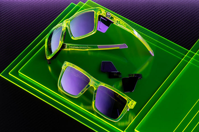 Two pairs of the Performance XL VISE Sunglasses Frame: Antifreeze Z87+ sitting on a neon green platform