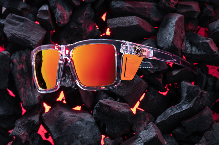 Side View of Heat Wave Performance XL Vise Vapor Clear Sunblast safety sunglasses with orange red side shields and hot bbq coals behind them.