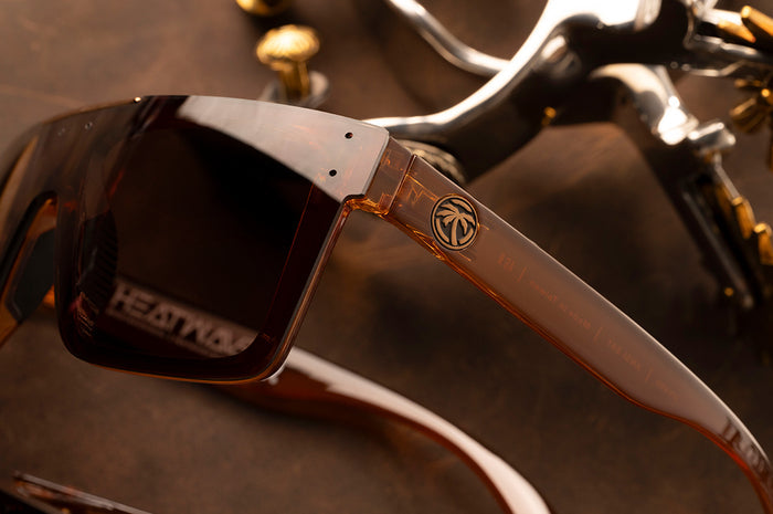 Close up shot of the Quatro Sunglasses: Saddle Z87 on wood table