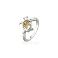 Honu ring made in sterling silver with blue sapphires eyes and a 14k yellow gold plumeria on its shell. Item No. 44724