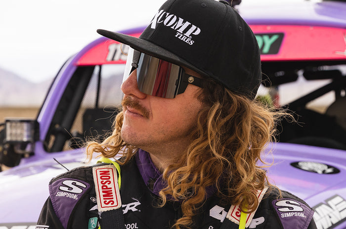Black Wilkey wearing Heat Wave Visual Vector Sunglasses with black frame and silver lens.