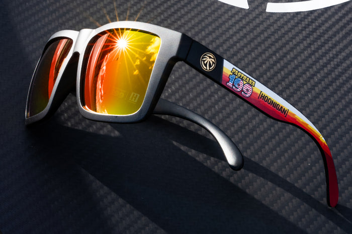 Lying on carbon fiber is the Heat Wave Visual Vise Hoonigan Pastrana Sunglasss.