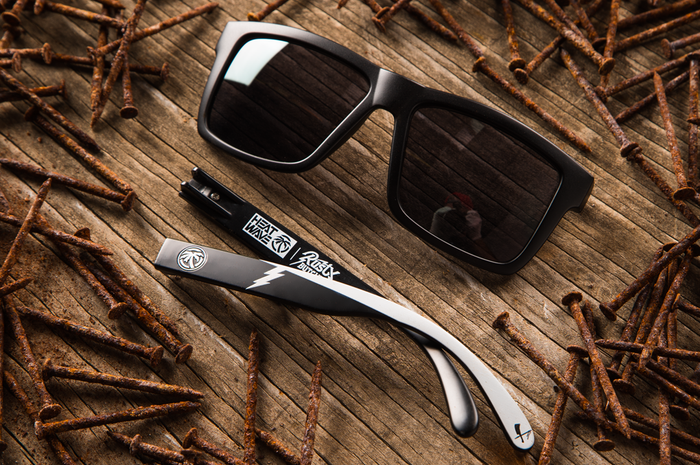 Heat Wave Visual Rusty Butcher Vise Sunglasses lying on the wooden floor surrounded by rusty nails.