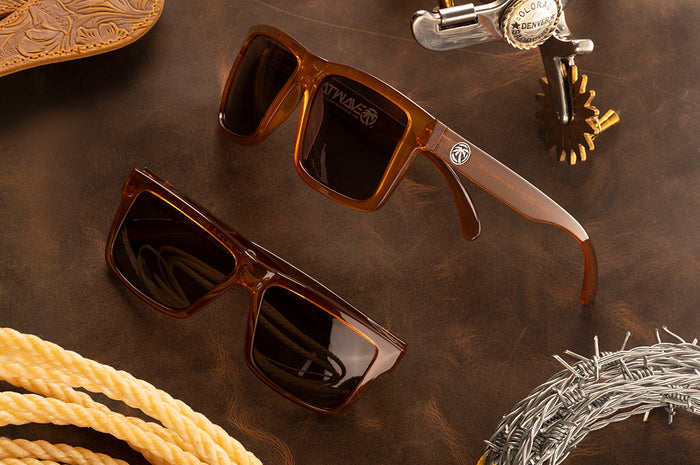 Two pairs of the VISE Sunglasses: Saddle Z87 on a wood table.
