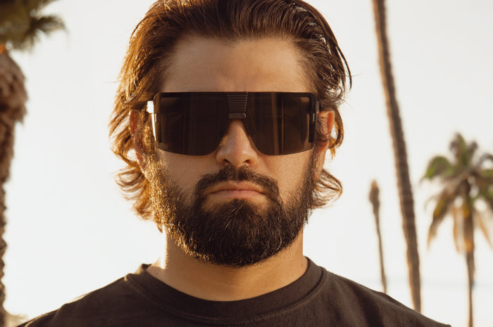 Esmarco out at the beach wearing the Heat Wave Visual XL Vector Sunglasses.